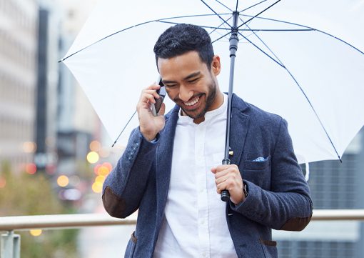 Wiley Insurance business man walking with umbrella