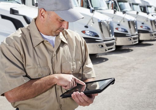 Wiley Insurance Services | Rock Hill, SC | man on table standing in front of fleet of trucks