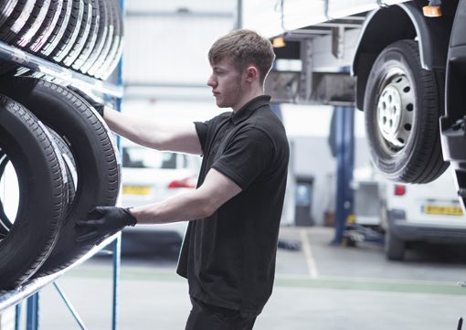 Wiley Insurance worker choosing tire for auto